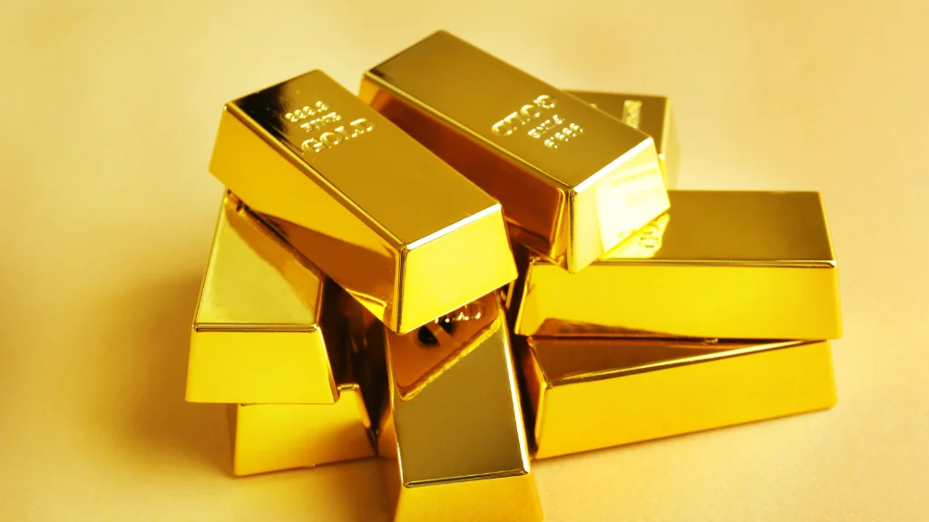 Digital gold investment displayed on a smartphone with gold bars in the background